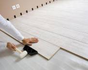 Taping laminate flooring with a rubber mallet